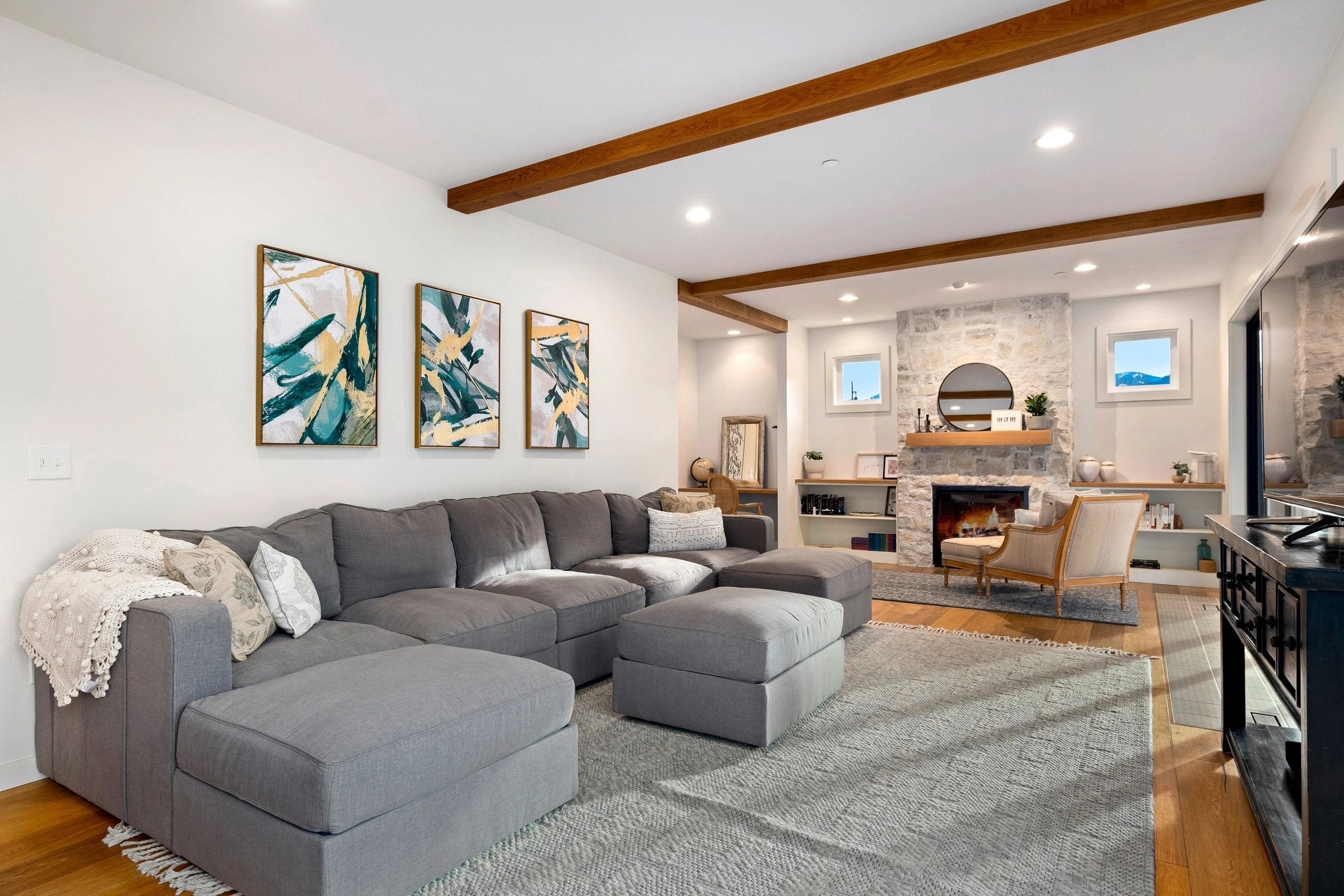 A living room with gray furniture and white walls.