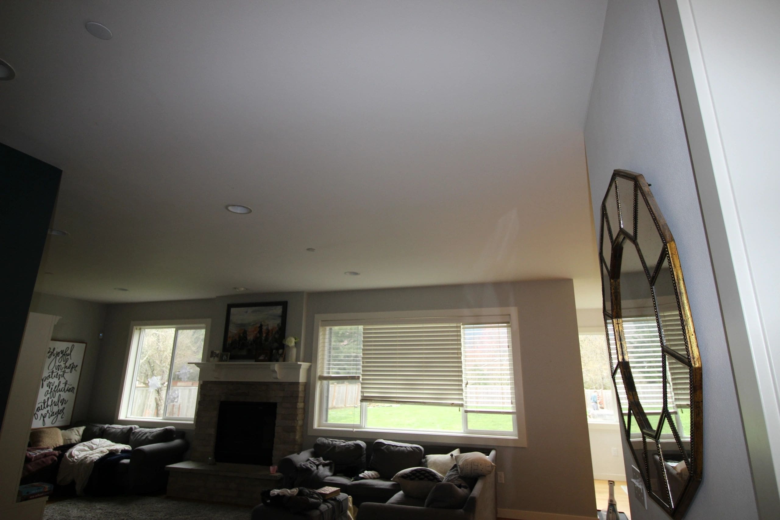 A living room with a fireplace and a large window.