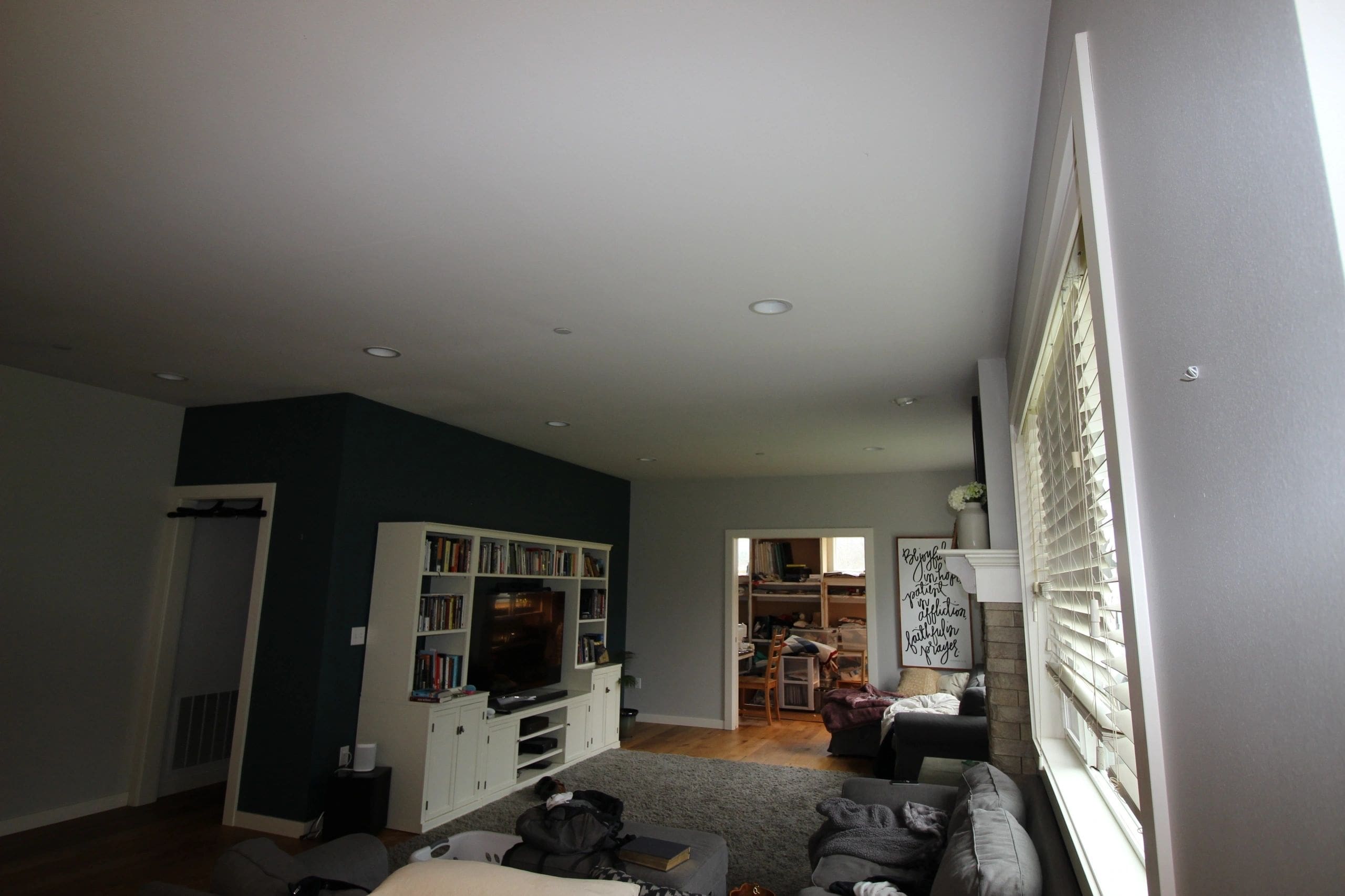 A living room with a large window and a television.