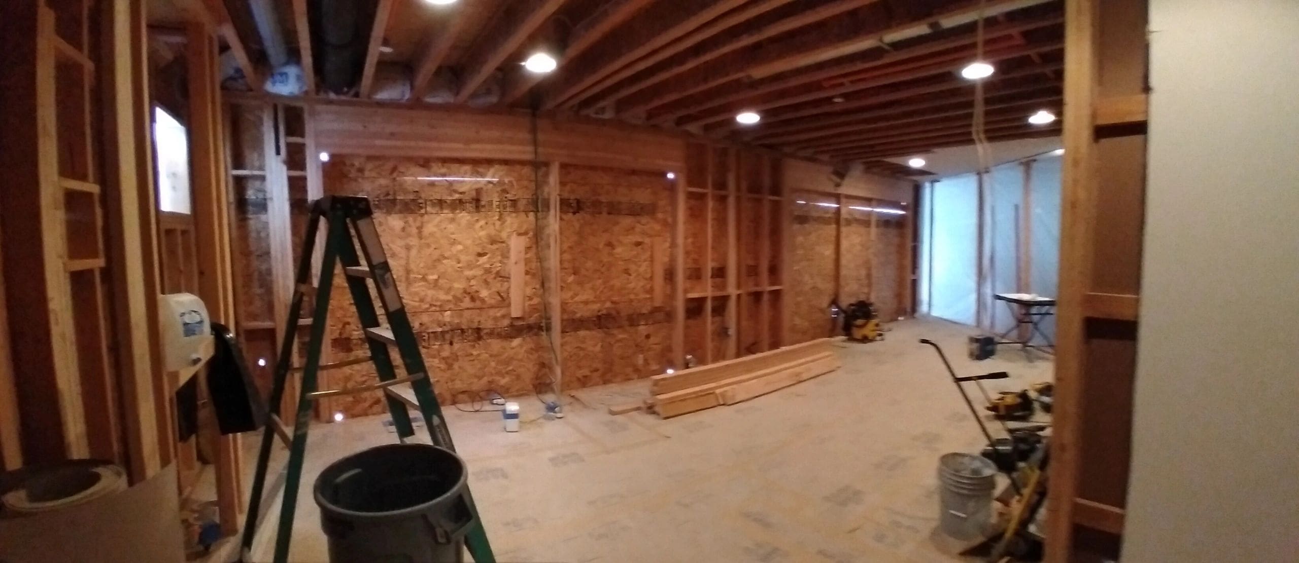 A room being remodeled with wood in the middle of it.