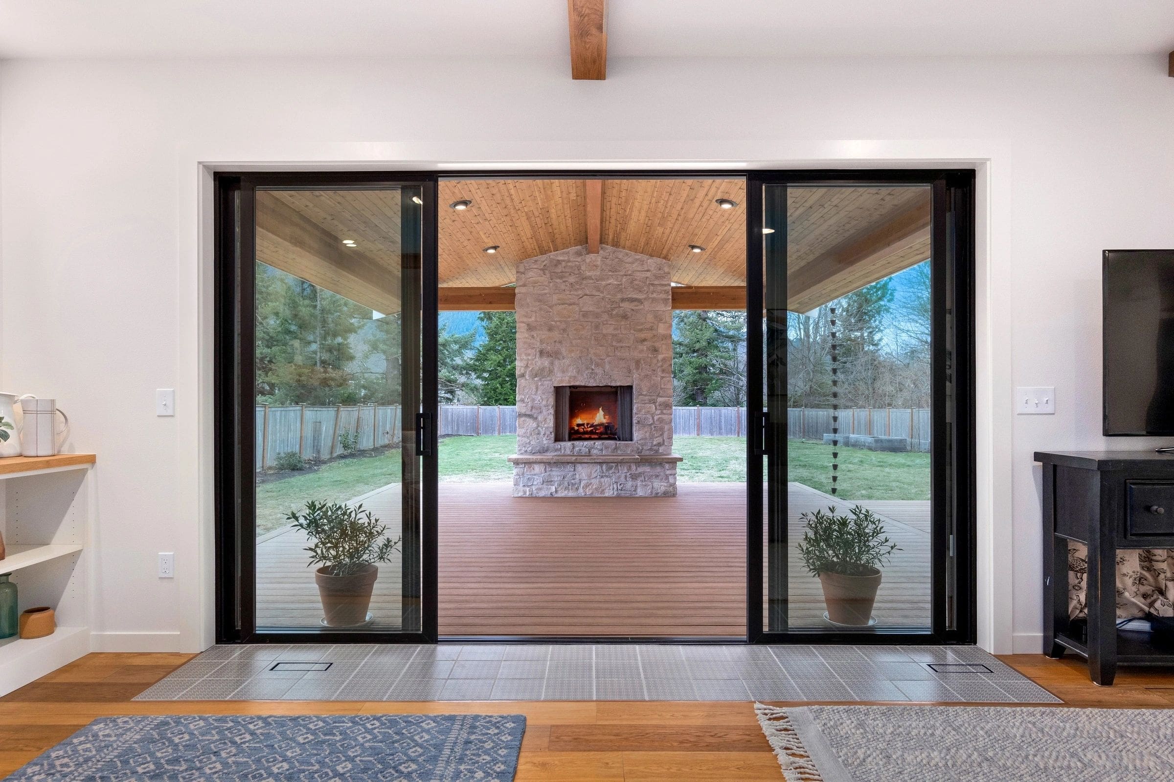 A large open patio door with a fireplace in the middle.