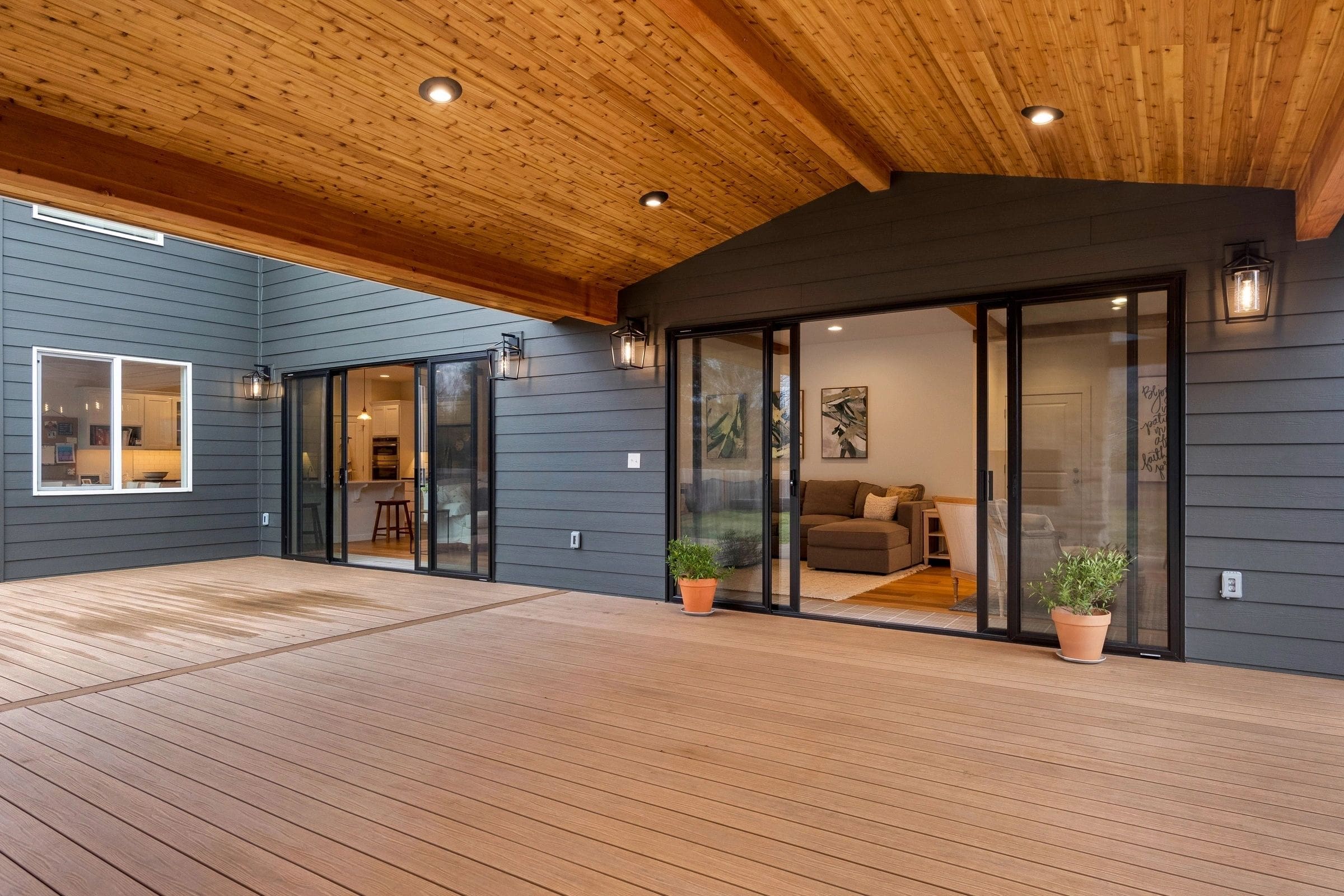 A large open porch with sliding glass doors.