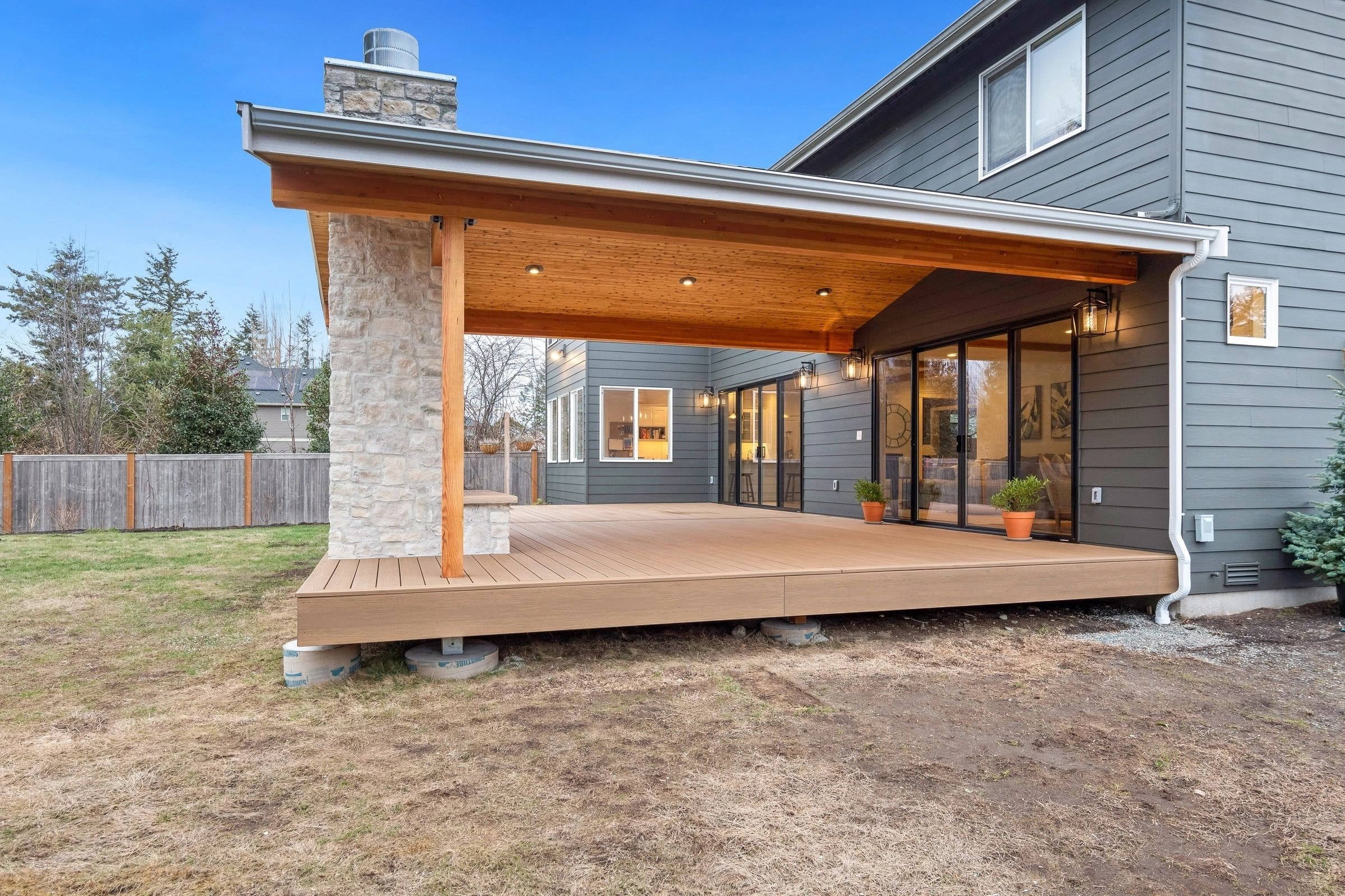 A large covered patio with a stone wall.