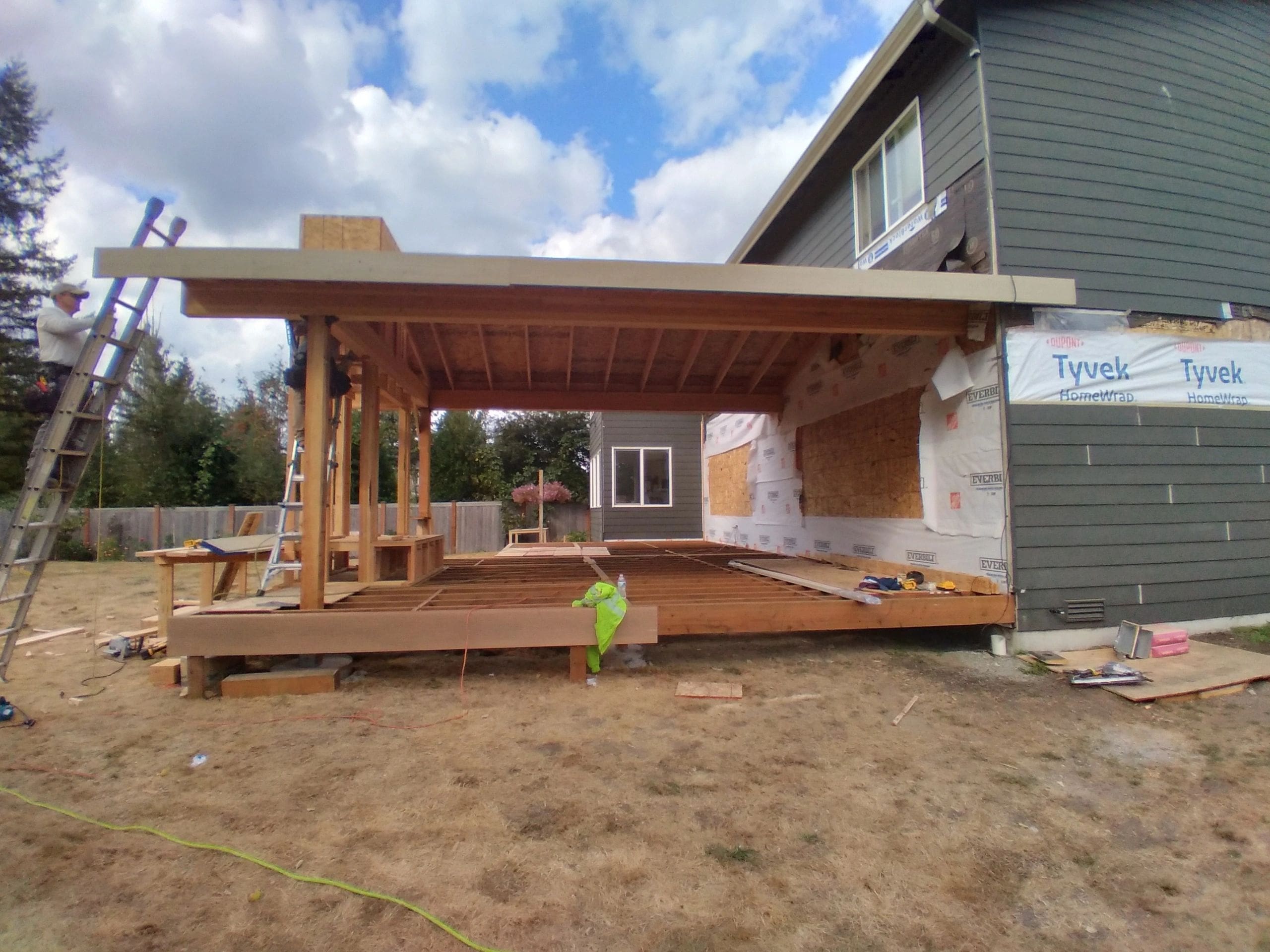 A house under construction with a fire hydrant in the foreground.