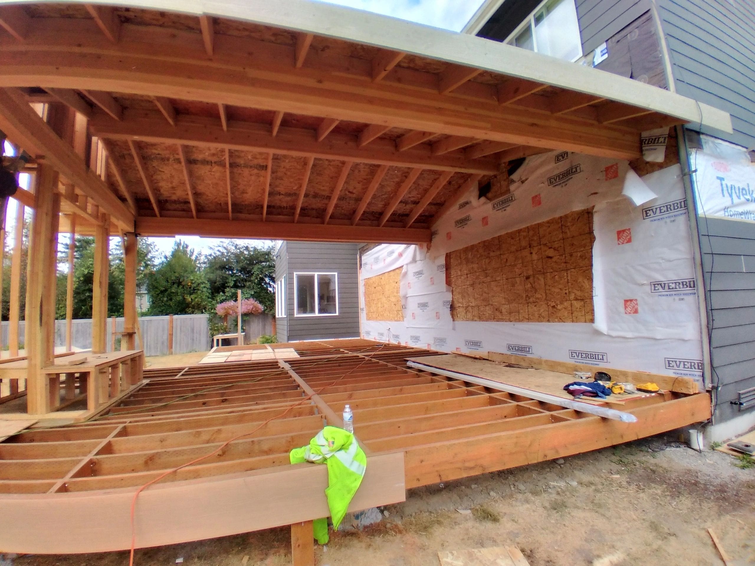 A wooden deck being built in the process of being installed.