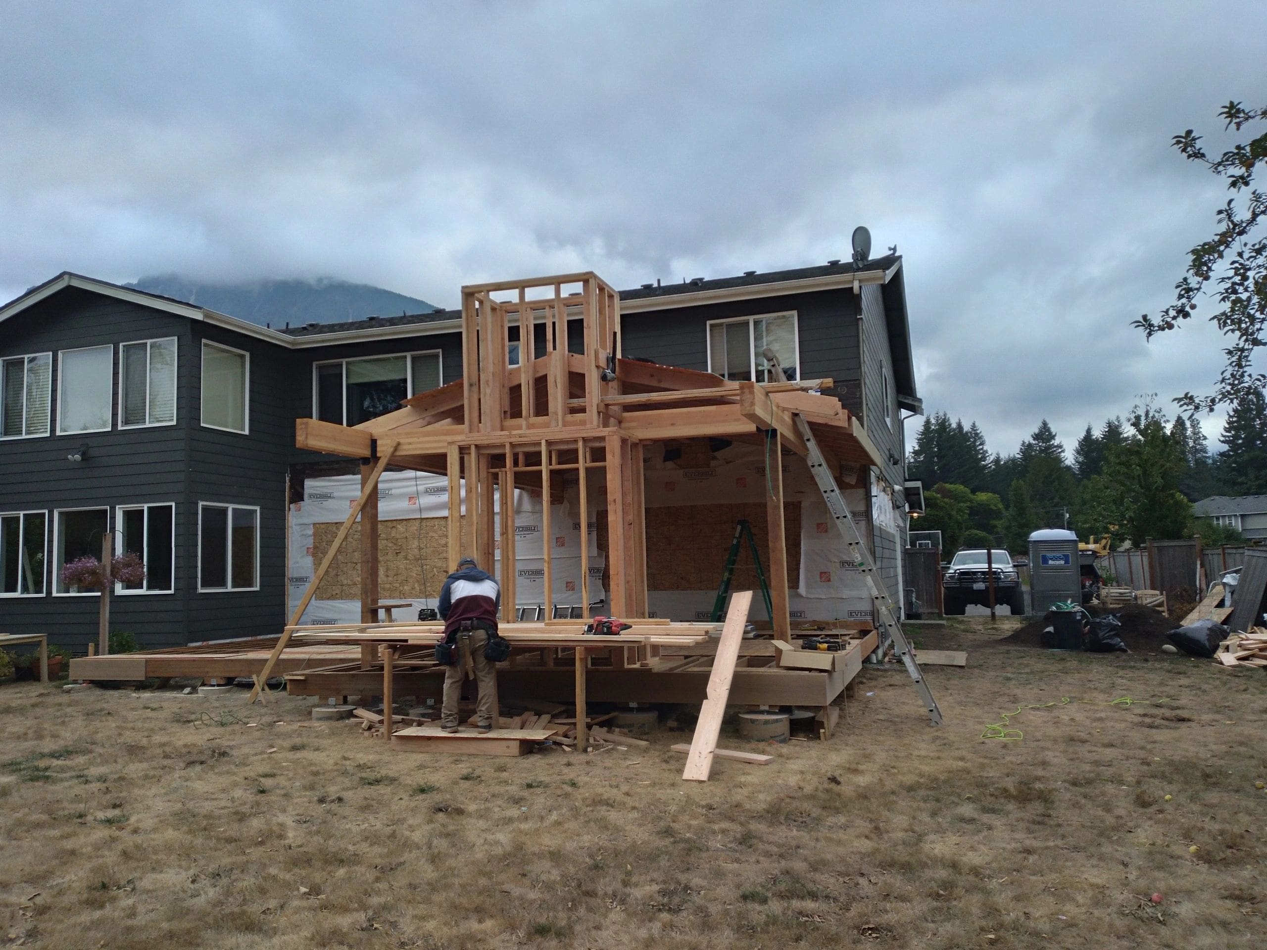 A man standing on the side of a house