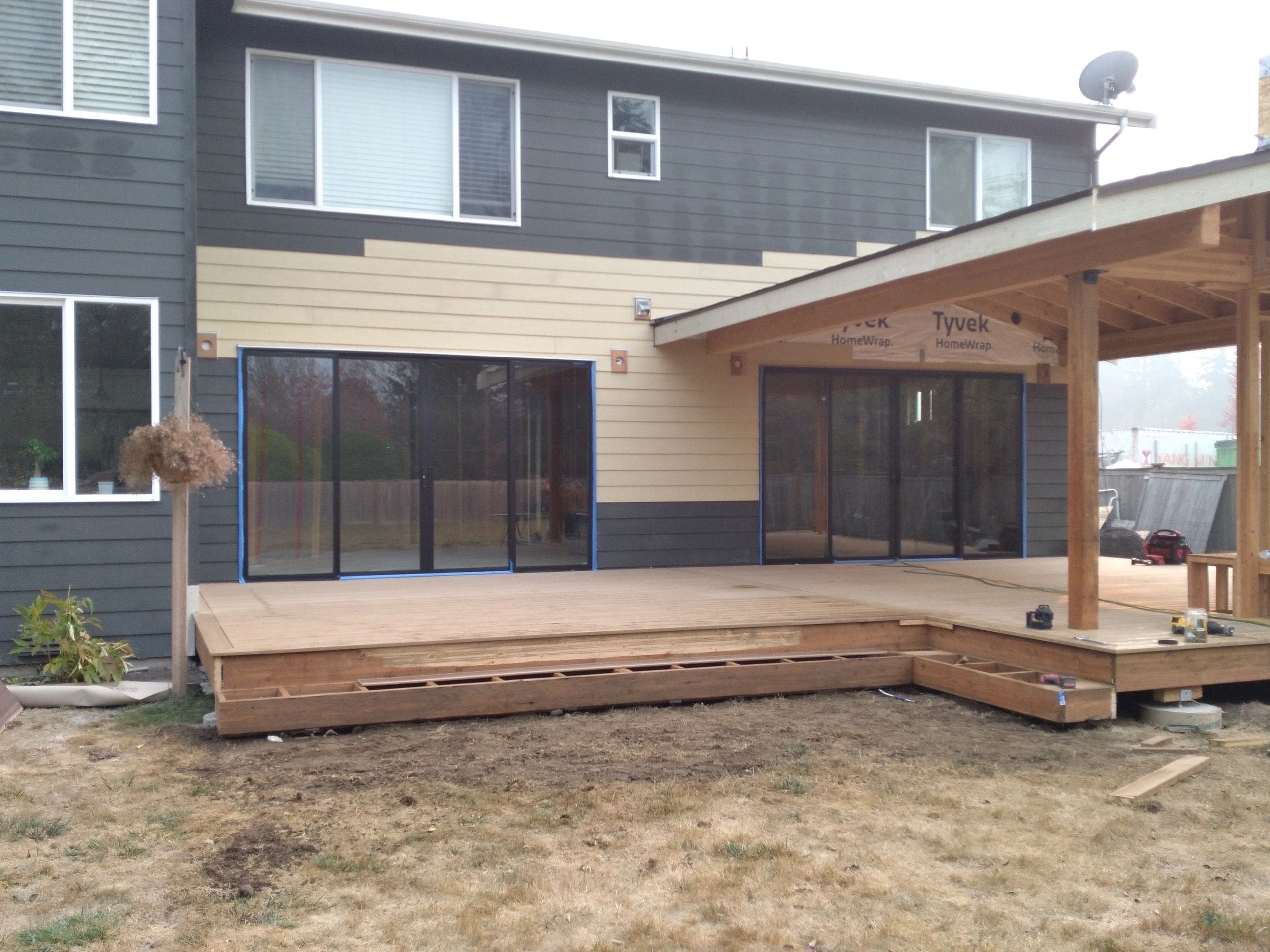 A house with a large deck and patio area.