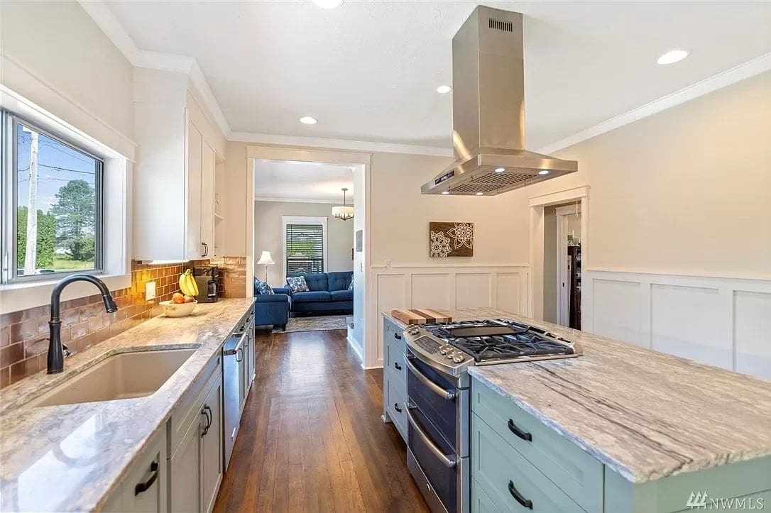 A kitchen with a stove and sink in it