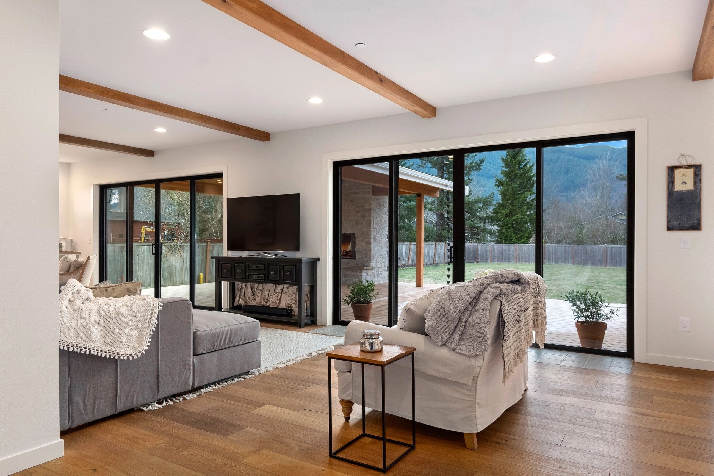 A living room with sliding glass doors and wood floors.