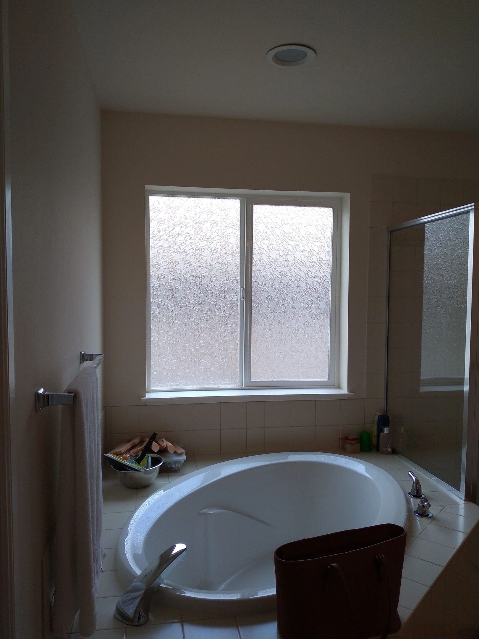 A bathroom with a tub and shower in it