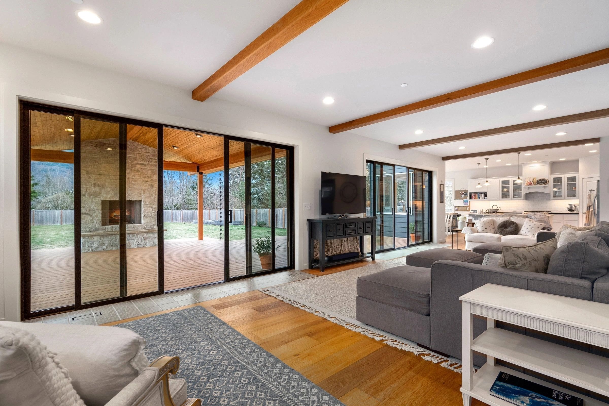 A living room with sliding glass doors and wood floors.