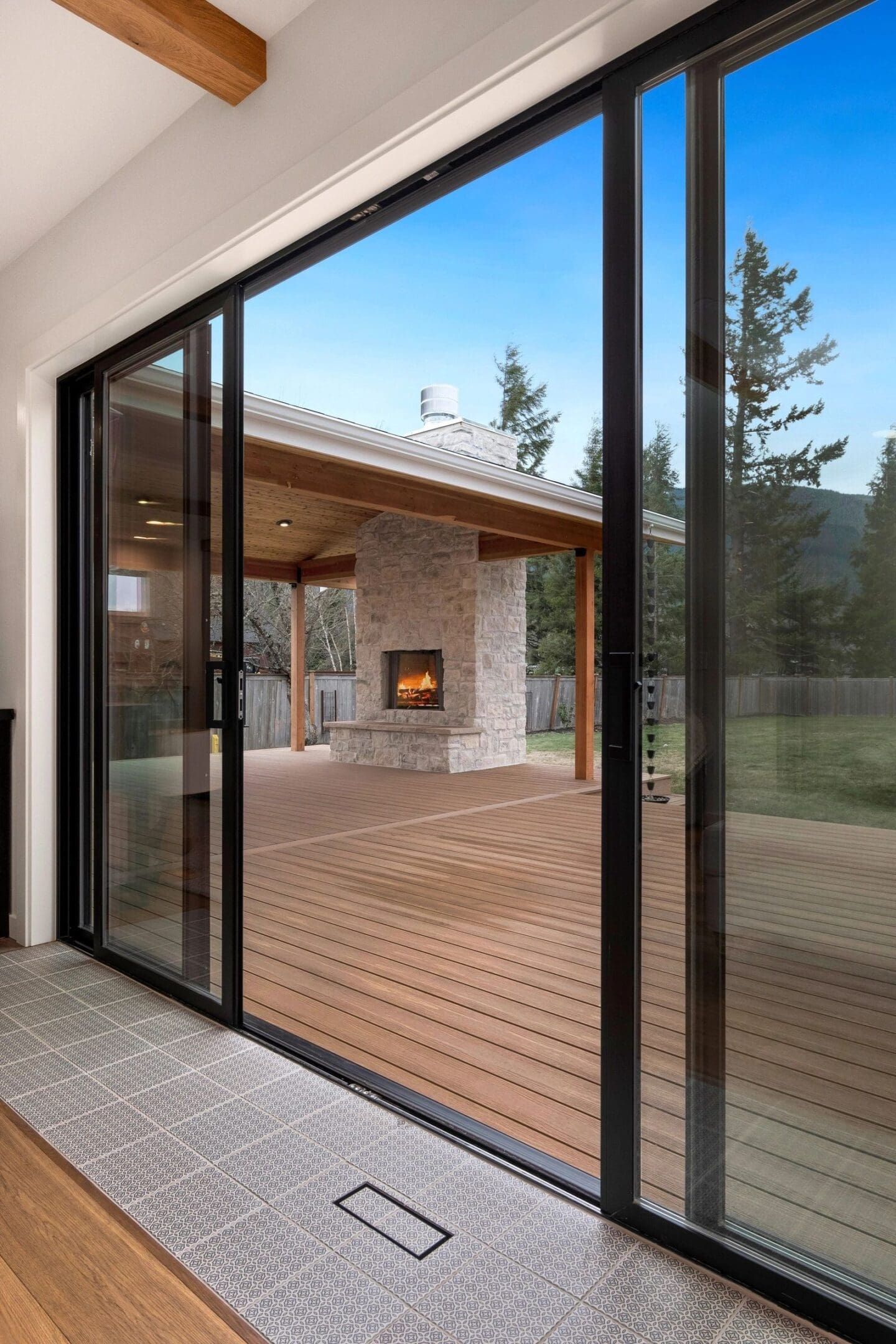 A large sliding glass door with a fireplace in the middle of it.