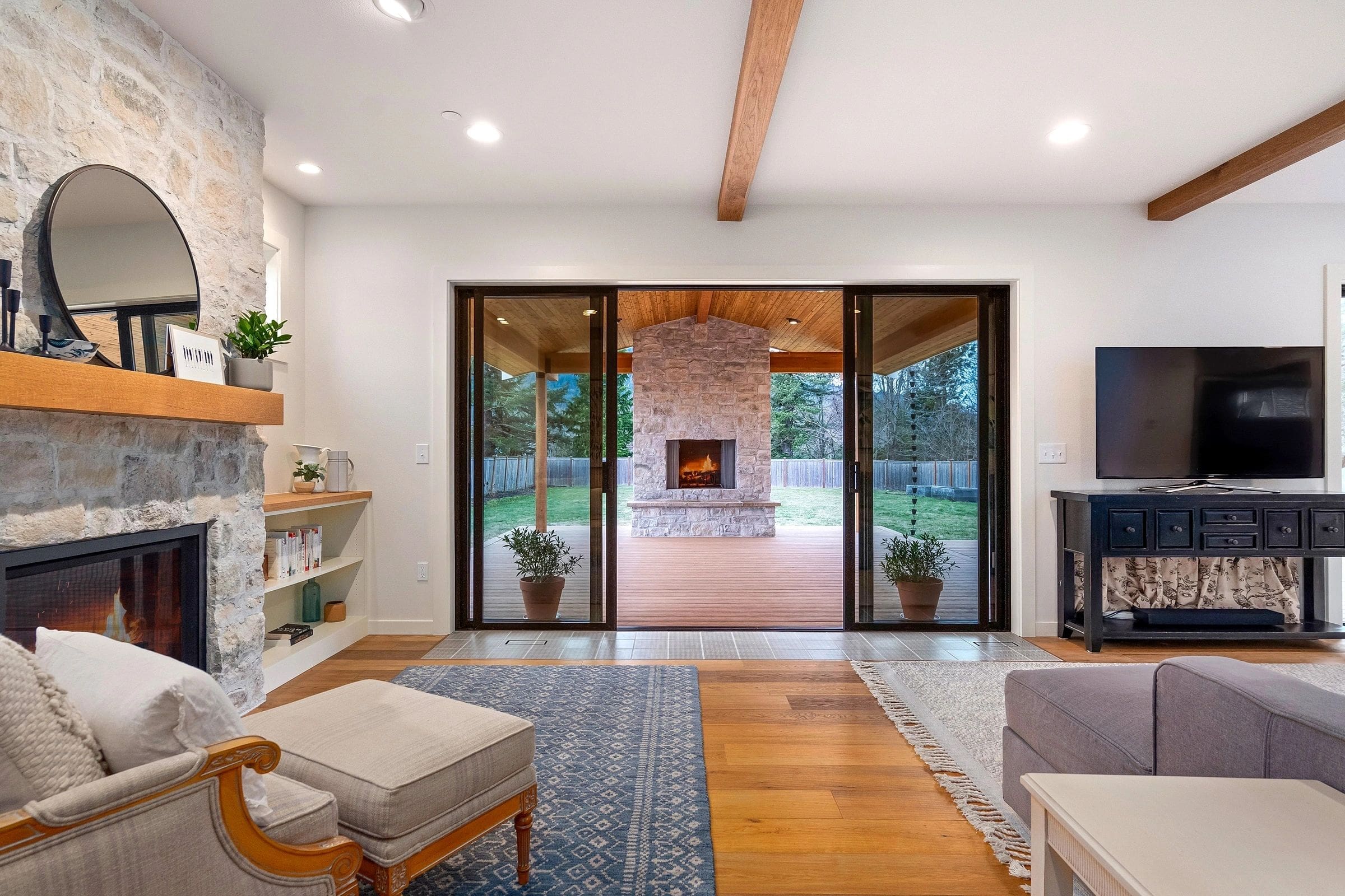 A living room with a fireplace and sliding glass doors.